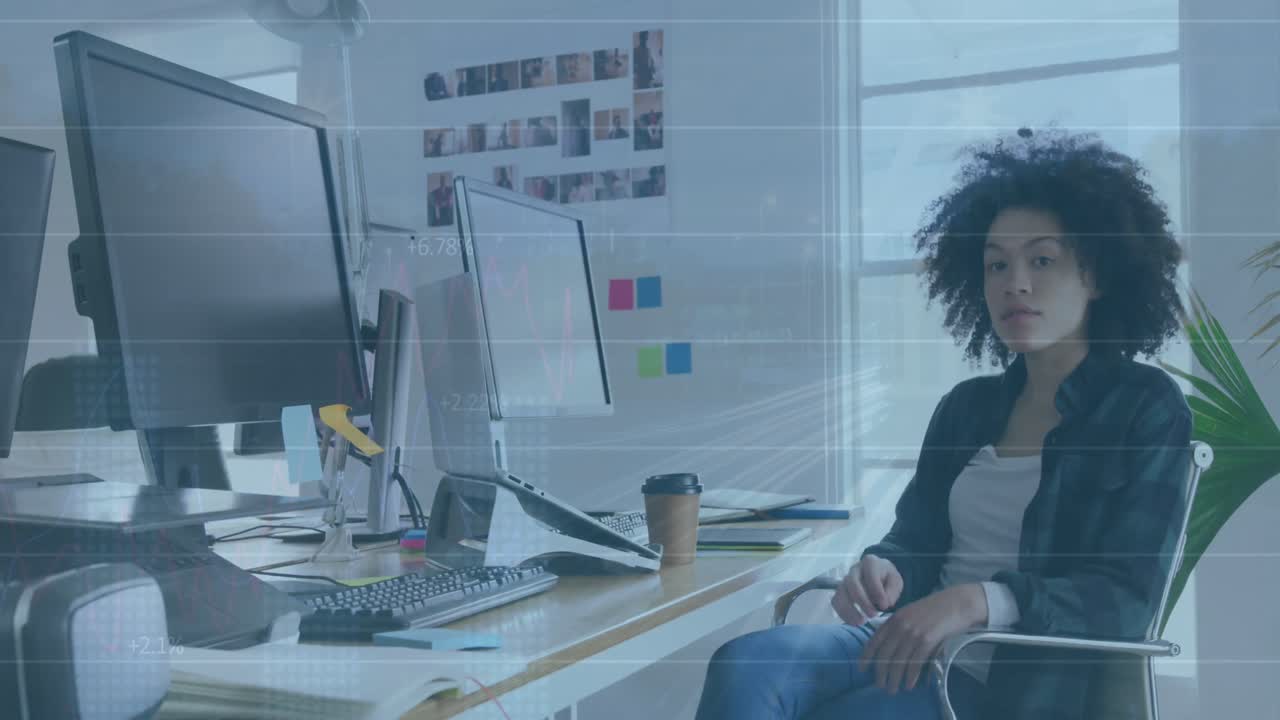 Animation of financial data processing over biracial businesswoman working in office