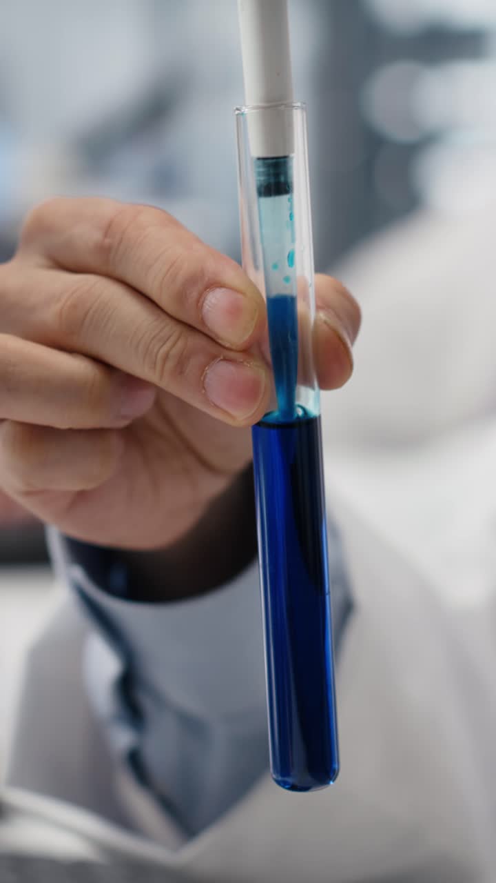 Vertical video Close up of lab technician does pipetting procedure
