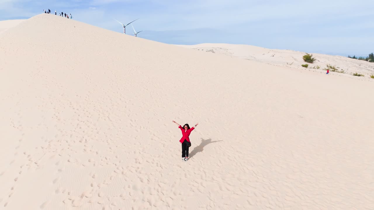 Aerial View of a Girl Standing and Walking on the Hill in the Desert.