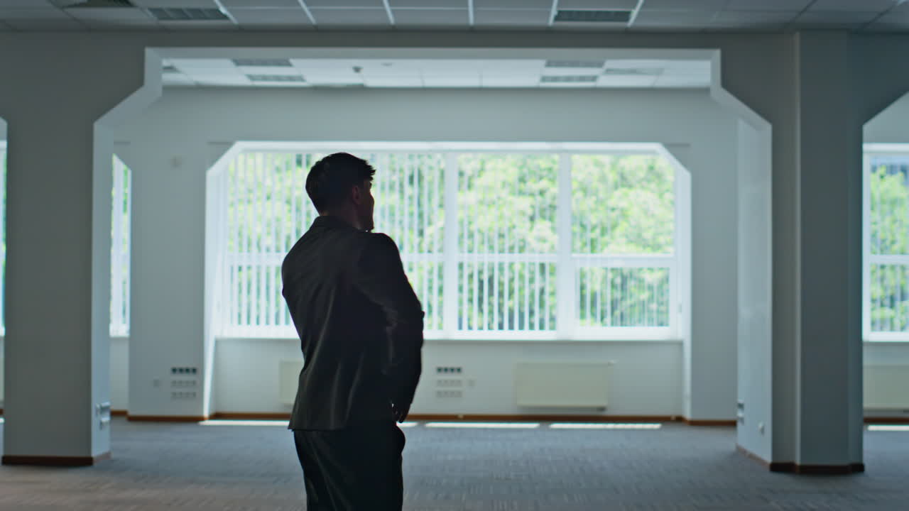 Boss silhouette talking cellphone standing architecture building. Man calling