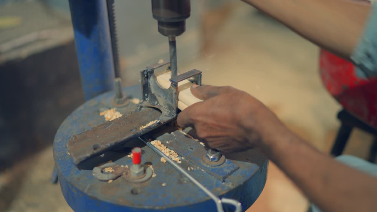 Close up shot of a man chipping of wood for making tent in Pakistan