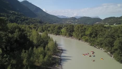 several-different-floating-boats-going-upon-a-river-in-France,-chateauroux-des-alpes