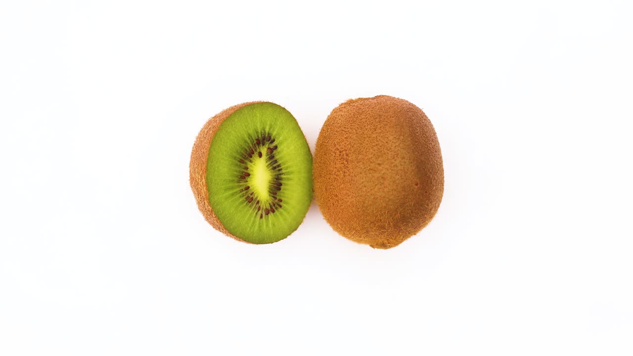 One and half fresh kiwi rotating on white background - Stop motion