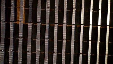 abstract drone riser view over rows of pv solar panels, combating climate change