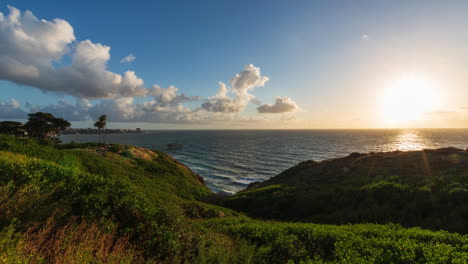 sunset time lapse of pacific ocean in california from a valley hill with rolling clouds