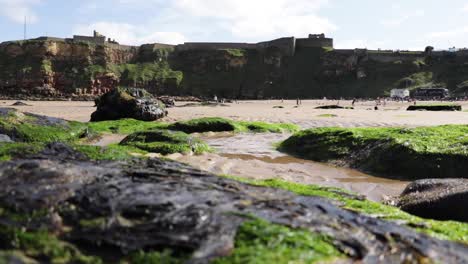 Panning-shot-of-a-sandy-beach-surround-by-cliffs