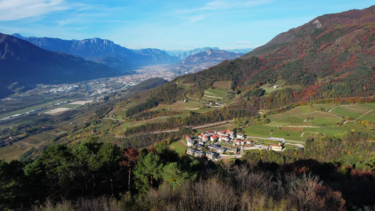 Aerial view of the city of Trento and Valsorda village, Adige River and colourfull mountains in Italy from Doss Fornas Battery. Trento was seat of the Council of Trent in the 16th century