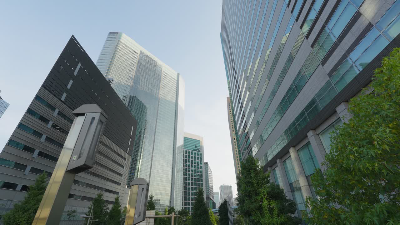 A low-angle view of modern, glass-covered skyscrapers and office buildings in a major financial district
