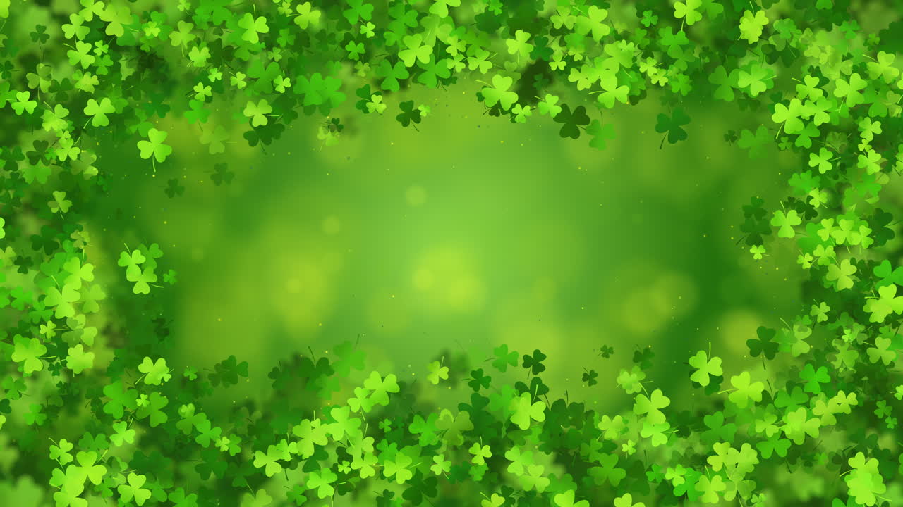 Rectangular animated frame with shamrocks on an abstract green looped background with beautiful bokeh. Copy space.