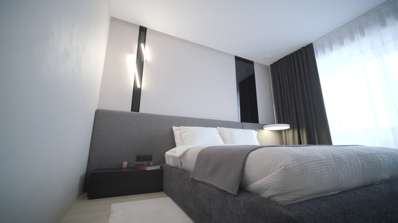 Moderne minimalistisk soveværelsesinteriør med komfortabel seng og moderne design