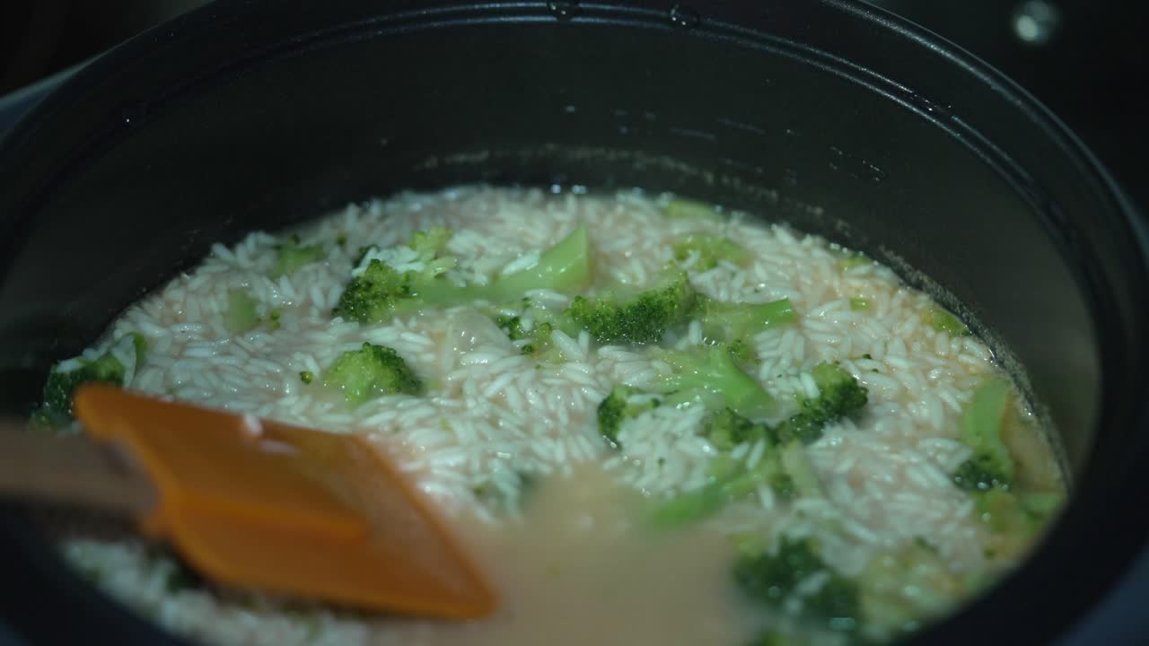 Shot of Rice and Broccoli Cooking in Rice Cooker