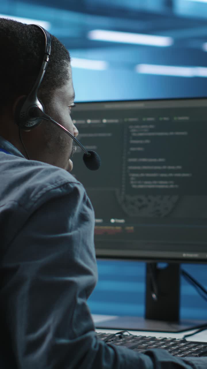 African American Man Working with Headset and Computer in Office