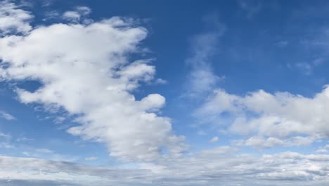 Cloudscape Cinemagraph Loop of White Puffy Clouds Drifting Across a Deep Blue Sky