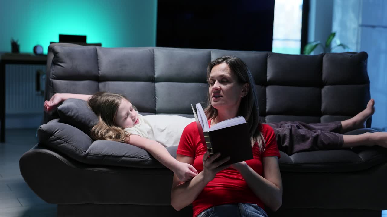 Mother Reading to Daughter on Couch