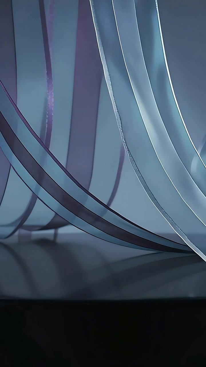 Vertical video: Entering edges spurring sheer strips undulating in studio on gloss table for study