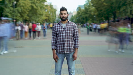 man in a plaid shirt on a city street