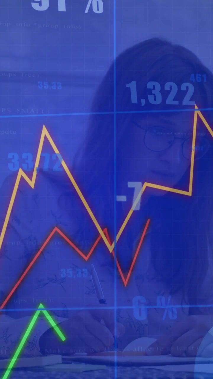 Vertical video: Woman writing notes for finance, causing overlay showing rising graphs and numbers