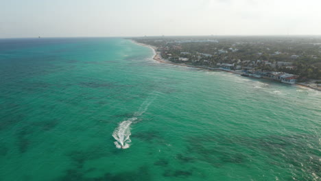 Atemberaubende-Luftaufnahme-Mit-Dem-Ruhigen-Karibischen-Meer-Und-Den-Stränden-Von-Playa-Del-Carmen.-Jet-Ski-Fahrer,-Der-Auf-Dem-Ruhigen-Wasser-Kreuzt