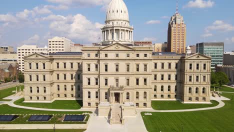 rising drone shot of the historic michigan state capitol building in downtown lansing
