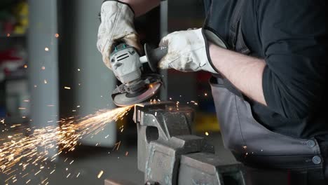 A-man-working-with-angle-grinder,-sparkles,-super-slow-motion,-close-up