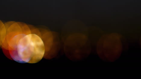 animation of orange spot lights over black background with copy space