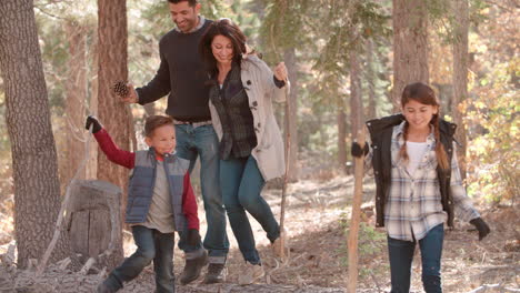 Hispanic-family-walking-in-a-forest,-close-up-front-view