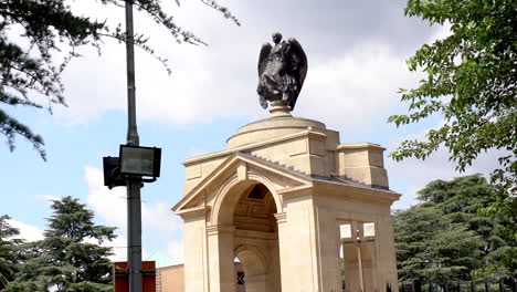 statue of angel on building, panning left to right wide shot