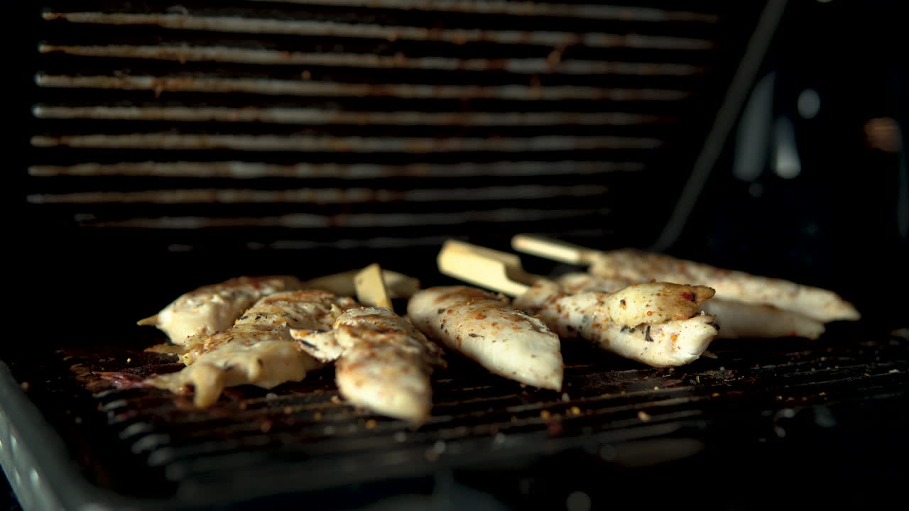 Close-up, open grill lid, chicken meat on grill plate