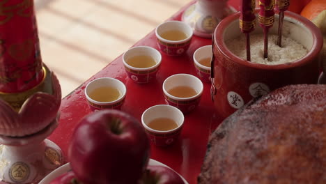 traditional red chinese tea cups filled for ceremony, close up