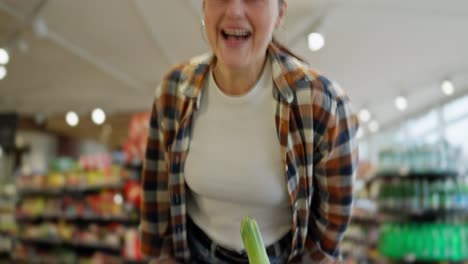 Portrait-of-a-happy-brunette-girl-in-a-plaid-shirt-who-rides-a-car-during-her-fun-shopping-in-the-supermarket