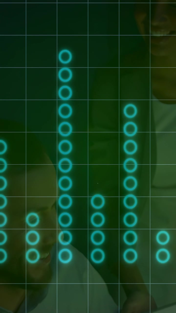 Vertical video: Duo leaning in offscreen audio playing teal EQ pulsing over faces reviewing data