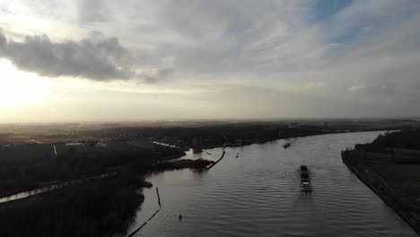 Cloudscape-Over-Sailing-Cargo-Ship-At-The-River-Of-Oude-Maas-Near-Zwijndrecht-In-Netherlands