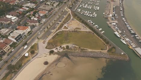 drone aerial over st kilda skate park and sandy beach with boats in the boat yard