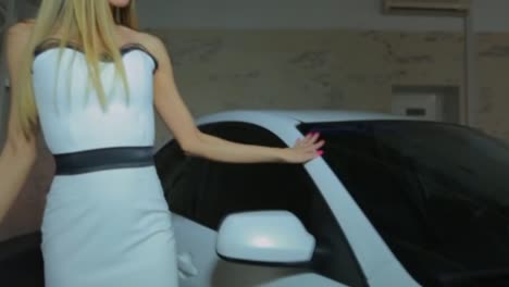 woman in white dress posing near a white car