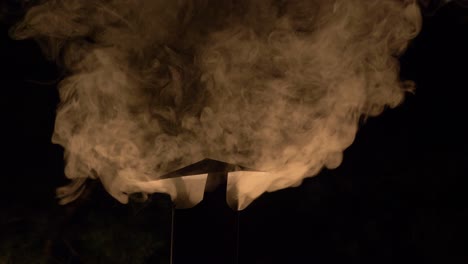 Clear-Images-Of-Smoke-Coming-Out-From-A-Traditional-Charcoal-Smoke-Griller-During-Winter-Night-At-Norwegian-Village-In-Arendel,-Zagorow-Poland