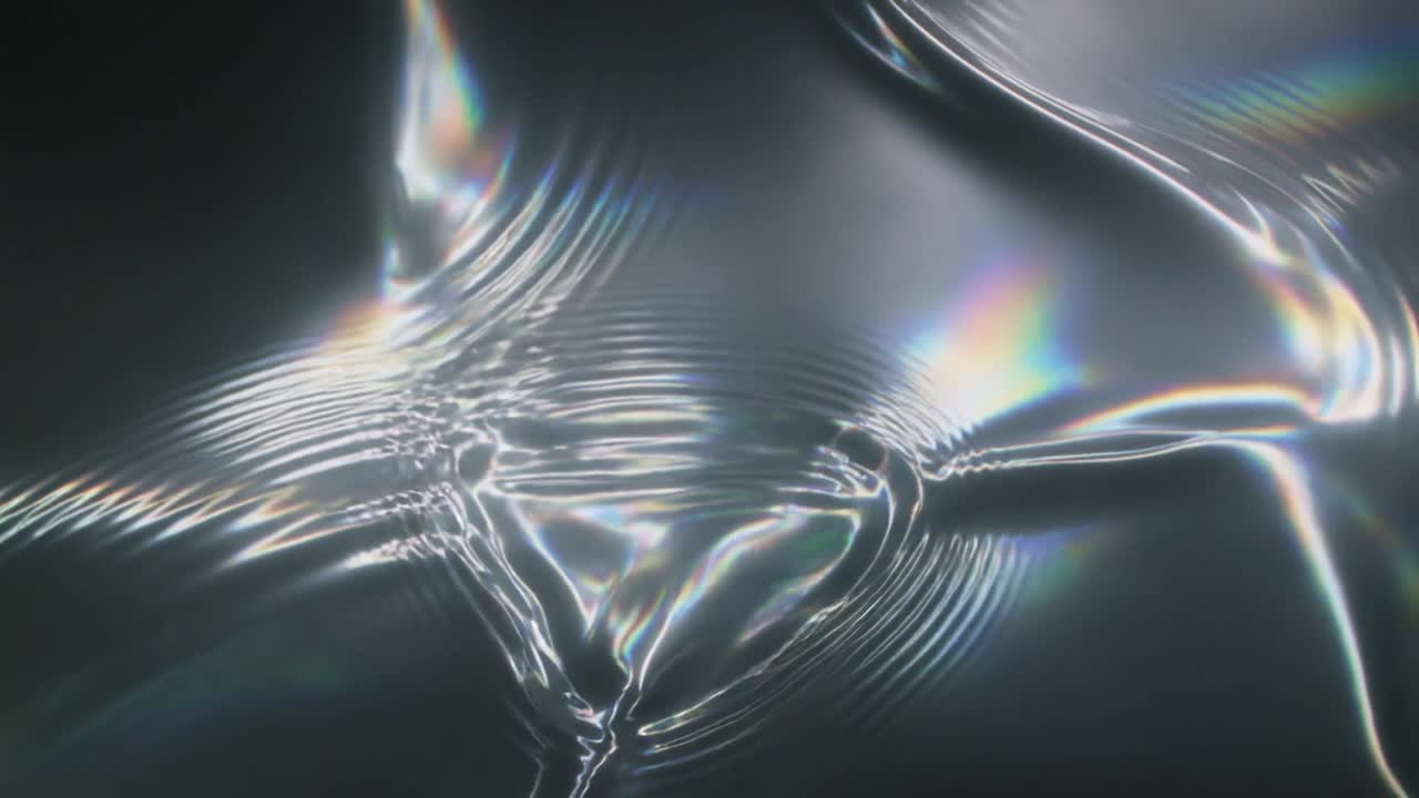 Rippling central glossy fluid film sending ripples from point nodes in lab, with prismatic glints