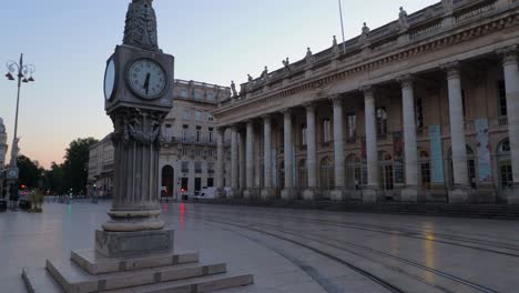 tall clock and opera house in bordeaux during sunrise with nobody wide arc