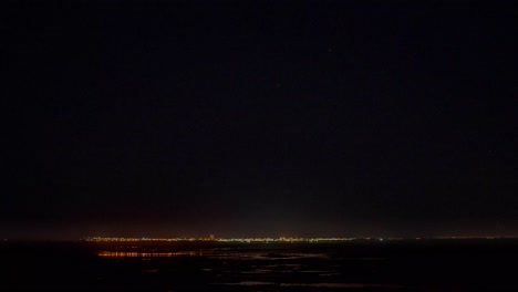 Time-lapse-of-Las-Grutas-in-summer-at-night,-Argentina,-wide-shot-hyper-lapse