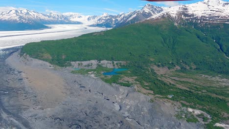 flying over the edge of knik glacier in the mountains of alaska, east of the town of palmer