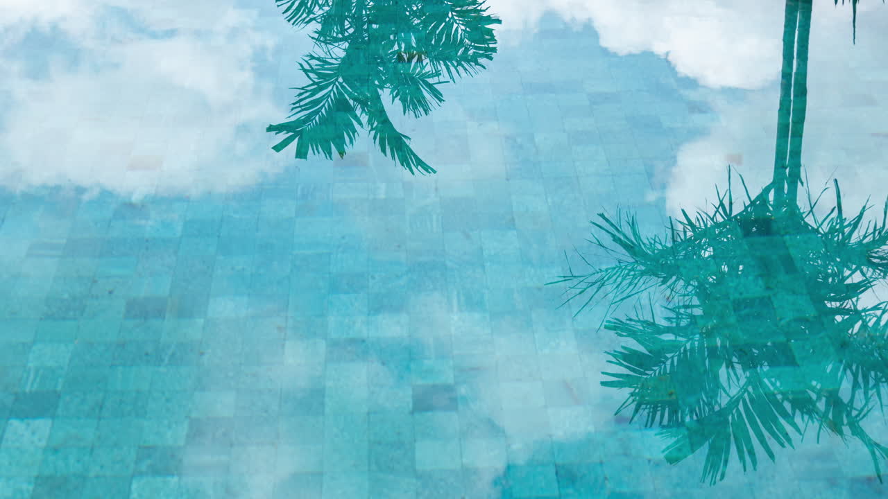 timelapse of luxury swimming pool set with reflections of clouds in the water