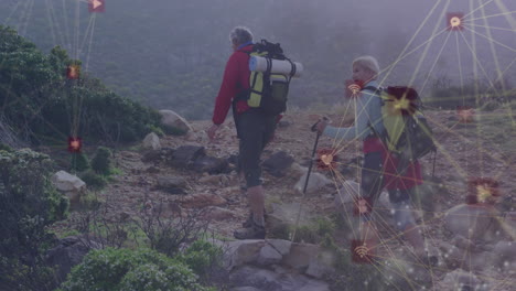 man and woman hiking uphill on rocky mountain trail, adding digital network overlay with wifi icons