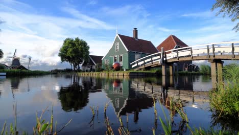 cheese factory building at zaanse schans reflected on the calm canal water, in zaandam, neterlands