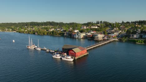 aerial shot orbiting coupeville's historic wharf, home to the local sailors