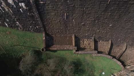 top down aerial view rising above scar house reservoir infrastructure high angle view overlooking dam lake water