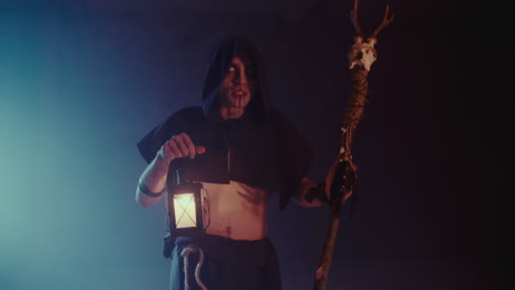 dark fantasy figure with staff and lantern