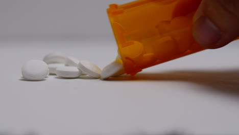 bottle of pills spill out of prescription bottle