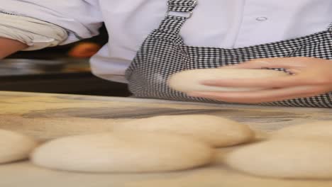 baker kneading dough in a bakery