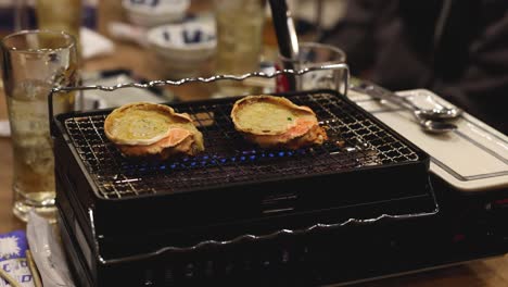 preparing seafood dish on tabletop grill