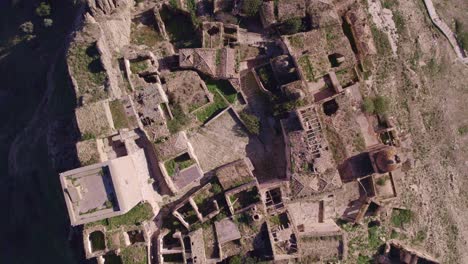 Top-down-of-deserted-old-ghost-town-Craco-in-Italy,-tourist-destination