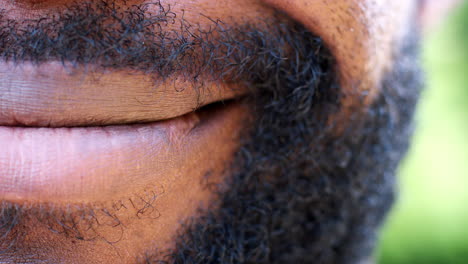 close up of one side of the mouth of a smiling black man